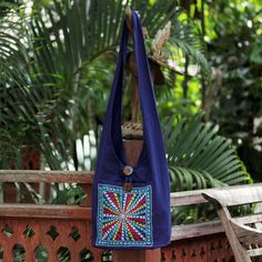 Embroidered by hand stars form a dazzling pattern on a cotton sling tote. The motifs cover a generous front pocket. By Jiap Rojjana the bag is fully lined and an inner pocket with zipper keeps small items handy. Both the outer pocket and the purse close with coconut shell buttons. Because each is an individual work of embroidery art colors and motifs may vary slightly according to the artisan's inspiration. Elephant Bag, Spirit Clothing, Cotton Handbag, Ribbon Jewelry, Printed Jewelry, Flip Flop Shoes, Shell Buttons, Coconut Shell, Premium Gift