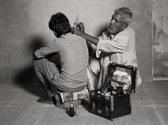 two people sitting on the floor with tools in their hands