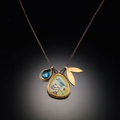 Symbolizing happiness and the coming of spring, this lovely charm necklace features a tiny original acrylic painting on watercolor paper, covered with a clear glass crystal. Set in a 22k gold bezel and accented with a rose cut london blue topaz charm, and a solid 22k gold leaf charm. Sterling silver backing and oxidized sterling silver chain. Matte finish. Painted pendant is 5/8 inch tall. Infinity Charm Bracelet, Micro Mosaic Jewelry, Leather Charm Bracelets, Blue Topaz Necklace, Topaz Jewelry, Sterling Silver Charm Bracelet, Silver Charm Bracelet, Diamond Star, Crystal Set