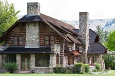 an old log house with stone chimneys