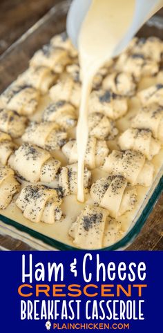 the batter being poured over cheese cubes in a glass baking dish on a wooden table