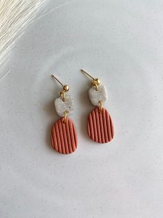 the earrings are made out of clay and gold