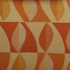 an orange and white fabric with leaves on it