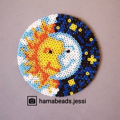 a round beaded brooch with an image of a lion on it