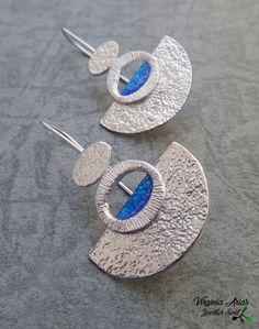 "Handmade Silver Art Deco Earrings made of sterling silver and blue enamel. The dangle earrings are inspired by art deco with geometric shapes and modern texture on its base. Modernist and contemporary, these femenine sterling silver earrings you can wear everyday. Details: Weight: 2.3 g each one Width: 22mm = 0.87\" Height: 35mm = 1.38\" Enjoy and thank you for looking! Follow me www.facebook.com/jewelersoul Visit my shop for a matching more pendants: https://www.etsy.com/es/shop/JewelerSoul?se Contemporary Silver Jewelry With Artistic Design, Blue Fusion Earrings For Pierced Ears, Contemporary Blue Jewelry For Gifts, Modern Blue Metal Earrings, Blue Fusion Drop Earrings, Blue Fusion Style Drop Earrings, Blue Fusion Style Round Earrings, Artistic Blue Round Earrings, Artistic Blue Metal Jewelry