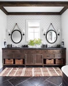 a bathroom with two sinks and mirrors on the wall