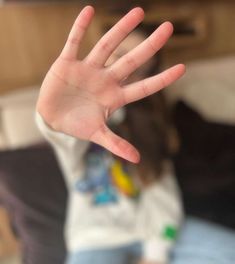 a person holding their hand up in the air