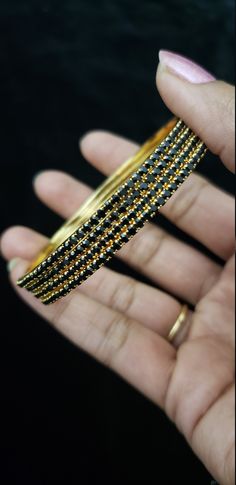 "* Handcrafted Gold Plated 4 Bangle Set. Sold as a set. * Bangles with high quality black stones. * High Quality 22K Gold Plated. Bangles Sizes : 2.4 inches= ( 2.25\" diameter of the inner circle) ; 2.6 inches = ( 2.40\" diameter of the inner circle); 2.8inches = (2.54\" diameter of the inner circle) The gorgeous gold-plated bangles set best exemplifies the careful craftsmanship done on it -- specially picked for you by Nemali Jewelry. It has a special tone of elegance attached to it. The intric Traditional Black Bracelets For Party, Traditional Black Party Bracelets, Traditional Black Bracelets For Weddings, Traditional Black Bracelet For Wedding, Traditional Black Wedding Bracelets, Black Bangle Bracelets For Festive Occasions, Festive Black Bangle Bracelets, Traditional Black Bangle Gift, Festive Black Bangle Bracelet