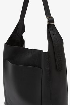 Black leather shoulder bag from The Row. The Black hobo bag is softly structured in grained calfskin leather complete with an adjustable shoulder strap, exterior back pocket, and removable interior zip pouch.Measurements: L30 x H13 x W9 cmMade in Italy Black Pebbled Leather Shoulder Bag For Everyday, Chic Black Calf Leather Hobo Bag, Chic Calf Leather Crossbody Hobo Bag, Pebbled Leather Shoulder Bag For Business, Chic Calf Leather Hobo Bag With Adjustable Strap, Chic Calf Leather Hobo Bag With Removable Pouch, Soft Calf Leather Hobo Bag For Travel, Business Soft Leather Crossbody Hobo Bag, Calf Leather Hobo Bag With Leather Lining