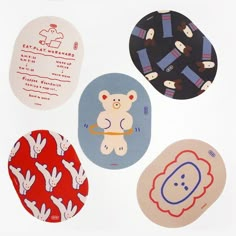 four circular stickers with various designs on them, all in different shapes and sizes