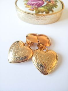 "🌹Lovely vintage gold heart earrings from a 90s deadstock, never worn and in excellent condition. These gold heart drop earrings are carved, shiny puffy drop hearts, made of resin with a brass clip on closure made with a good quality gold tone plate. They are quite lighweight. (See measurements and weight below). I offer a matching necklace on this listing: https://bit.ly/heartchainnecklace . Adding it to your order won't add shipping costs and will add a discount. MEASUREMENTS: 📏Heart length: Gold Heart Shaped Clip-on Earrings For Wedding, Heart-shaped Clip-on Wedding Earrings, Wedding Heart-shaped Clip-on Earrings, Gold Clip-on Earrings For Valentine's Day Gift, Vintage Heart Charm Earrings For Valentine's Day, Gold Heart-shaped Clip-on Earrings For Anniversary, Heart-shaped Clip-on Earrings For Valentine's Day Anniversary, Heart-shaped Clip-on Jewelry For Anniversary, Valentine's Day Heart Shaped Clip-on Earrings For Anniversary