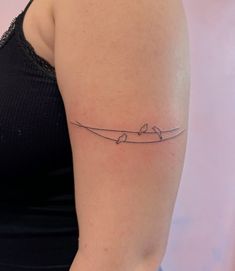 a woman with a small tattoo on her arm