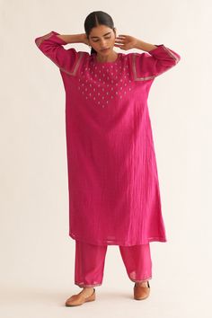 Bright pink chanderi A-line kurta with round neck, floral pattern resham, gold zari hand embroidered yoke and sleeves. Paired with straight fit pants.
Components: 2
Pattern: Hand Embroidered
Type Of Work: Resham and Zari Work
Neckline: Round Neck
Sleeve Type: Three Quarter Sleeves
Fabric: Chanderi
Color: Pink
Other Details: 
Embroidered border on pants
Side slits on kurta
Keyhole back
Kurta Closure: Back loop button
Occasion: Puja - Aza Fashions Kurta And Dupatta, Kurta Pant Set, Beautiful Casual Dresses, A Line Kurta, Straight Fit Pants, Kurti Designs Party Wear, Embroidered Border, Designer Dresses Casual, Boutique Dress Designs