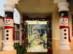 an entrance decorated with snowmen and christmas decorations