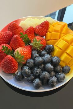 a white plate topped with fruit and cheese