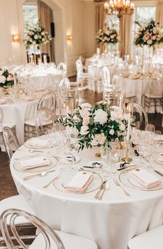 the tables are set with white linens, gold chargers and floral centerpieces