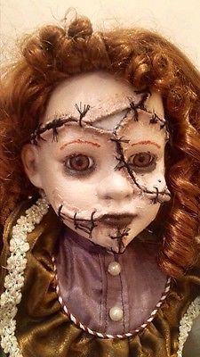 a creepy doll with red hair and makeup