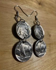 These earrings are made from authentic 1930s US Buffalo Nickel Coins. On the front side of the earring it shows both sides of the same coin one depicting an American Bison (Tails) and the other side depicting a Native American (Heads). The nickels are made from nickel and the earring is made of authentic silver. Both coins (4 in total) is the same size as a current day nickel. Vintage Nickel-free Medallion Jewelry, Vintage Silver Medallion Earrings, Vintage Sterling Silver Coin Jewelry, Vintage Antique Silver Coin Jewelry, Vintage Silver Coin Earrings, Antique Concho Jewelry For Gifts, Antique Concho Jewelry As Gift, Vintage Brass Earrings With Engraving, Antique Concho Jewelry For Gift