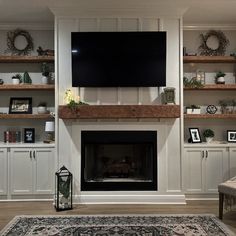 a living room filled with furniture and a flat screen tv mounted on the wall above a fireplace