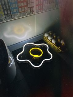 a neon sign sitting on top of a stove