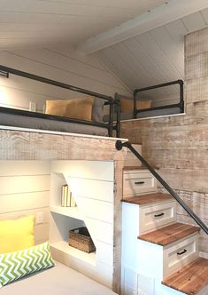 a loft bed is built into the side of a wall and has stairs leading up to it