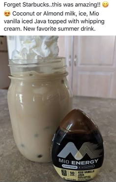 a jar filled with whipped cream next to an ice cream sundae on top of a counter