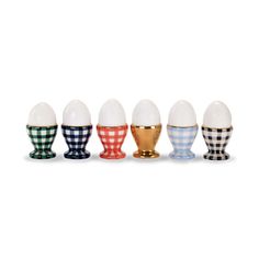 an assortment of different colored egg cups