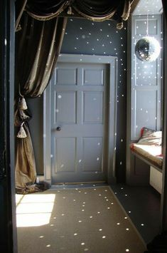 an open door leading to a bedroom with stars on the walls and carpeting around it