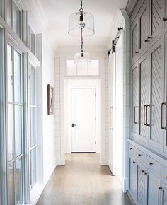 an empty hallway with white walls and wood floors