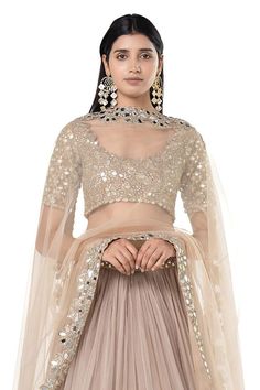 Moon grey lehenga with attached cancan, and mirror embroidered broad border. Comes with embroidered padded blouse and dupatta.
Components: 3
Pattern: Embroidered
Type Of Work: Mirror
Neckline: Scoop
Sleeve Type: Short
Fabric: Net
Color: Grey
Other Details: 
Pleated lehenga
Closure: Lehenga and blouse: Side zips
Occasion: Wedding,Bride - Aza Fashions Choli With Sheer Dupatta For Reception Navratri, Festive Choli With Sheer Dupatta For Reception, Eid Wedding Pre-draped Saree With Mirror Work, Navratri Reception Sets With Mirror Work, Reception Choli With Sheer Dupatta In Traditional Drape, Reception Choli With Sheer Dupatta And Traditional Drape, Navratri Organza Chandbali Choli, Navratri Chandbali Organza Choli, Kundan Pre-draped Saree With Sheer Dupatta For Reception