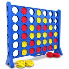 a giant connect game with red, yellow and blue circles next to stacks of gold coins