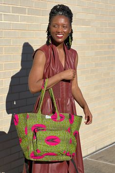 The bag that fits everything and is just everything! The Everything Bag fits all of your essentials stylishly. Handmade in Ghana from authentic Ankara. Disclaimer: Product color and quality seen may vary slightly compared to actual items due to photography lighting conditions and items being one-of-a-kind and cut from different parts of the fabric. Green Double Handle Travel Bag For On-the-go, Green Tote Bag With Zipper Pocket, Green Tote Bags With Zipper Pocket, Pink Tote Weekender Bag For On-the-go, Green Tote Weekender Bag For On-the-go, Green Bag With Zipper Pocket For Daily Use, Pink Handheld Hobo Bag For Travel, Green Tote Satchel With Zipper Pocket, Pink Tote Weekender Bag For Daily Use