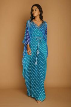 Blue-turquoise kaftan with all-over chevron print and V-neck. Comes with braided belt.
Component: 2
Printed, Embroidered
Neckline: V-Neck
Sleeve Length: Full
Fabric: Georgette
Color: Blue
Embellishments at the neckline
Braided belt with tassels - Aza Fashions Unique Kaftan Designs, Green Kaftan, Kaftan Styles, Kaftan Tunic, Printed Kaftan, Kaftan Top, Kaftan Designs, Embroidered Neckline, Designer Dresses Indian