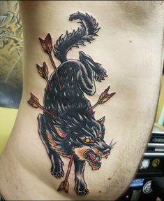 a man's stomach with an animal and arrow tattoo on the side of his body