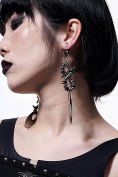 Embrace the perfect fusion of futuristic and punk aesthetics with our Mechanical Punk Metal Earrings / Ear Clips. These striking accessories feature a design composed of multiple spiral metal coils and irregular metal pieces, resembling a spiral galaxy. The bottom of each earring is adorned with a large oval metal plate, adding a bold and edgy element to the overall look. Crafted from premium materials, these earrings ensure durability and a distinctive style statement. Perfect fusion of futuris Black Metal Earrings For Alternative Fashion, Edgy Metal Plug Earrings, Silver Punk Plug Earrings For Parties, Gunmetal Punk Metal Jewelry, Modern Internally Threaded Metal Plug Earrings, Alternative Metal Earrings For Party, Alternative Style Metal Earrings For Party, Gothic Metal Earrings For Alternative Fashion, Edgy Metal Earrings For Party