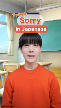 a young boy in an orange sweater standing in front of a classroom with chairs and desks