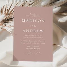 a wedding card with feathers on it