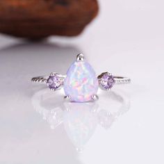 When it comes to the most stunning jewelry designs, we absolutely adore our gorgeous April Opal and Amethyst set. We've made each ring set with love by hand  using our premium sterling silver.  Finished with beautiful natural crystals, it's a design we know you will adore. ✦ DETAILS ✦ ✧ Purple fire opal and natural crystals  ✧ Sizes 3.75-11.25 ✧ This ring  will arrive ready to gift in a Kherish Jewelry Pouch. ✧ Due to the nature of the handmade process, each piece may slightly vary in color, size, shape, and contain natural inclusions. Every piece is gorgeous and one of a kind.  *Please refer to photos for reference.  ✦ This Artist Has Autism✦  Every item you order from Kherish is  handcrafted and packed by an artist with autism in RVA. Thanks to your support we are living our dreams.   Co Adjustable Purple Cubic Zirconia Jewelry, Pink Gemstone Jewelry For Birthday, White Cubic Zirconia Jewelry For Birthday, White Cubic Zirconia Birthday Jewelry, Purple Opal Ring Gift, Teardrop Gemstone Jewelry For Birthday, Dainty Amethyst Jewelry In White Gold, Dainty Amethyst White Gold Jewelry, Purple Opal Round Jewelry