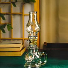 a glass lamp sitting on top of a green table