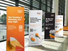 three roll up banners in front of windows with the words your branding and marketing just done right