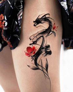 a woman's thigh with a tattoo design on the leg and flowers in it