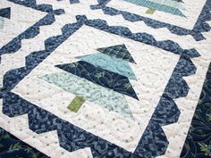 a quilted table topper with blue and green designs