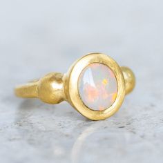 Our ancient inspired Talisman Ring has been set with a semi black opal from Lightning Ridge. Opal measures 9 x 8mm. Band width 2.5mm at back. Metal weight 11g approx. This ring is a size O in 14ct yellow gold with a matte finish. For a high shine finish, please leave a note at checkout. Please note, we can resize 1-2 sizes up or down. Gold Ethiopian Opal Heirloom Rings, Heirloom Ethiopian Opal Gold Rings, Gold Opal Ring With Spiritual Style, Gold Ethiopian Opal Ring Hallmarked, Heirloom Style Gold Opal Ring With Bezel Setting, Gold Opal Ring With Birthstone, Gold Opal Birthstone Ring, Heirloom Gold Opal Ring With Bezel Setting, Yellow Gold Ring With Ethiopian Opal And Birthstone