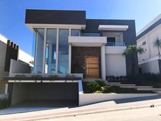 a modern house is shown on the street