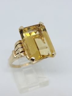 14K Yellow Gold Emerald Cut Citrine Solitaire Ring Size 8.5 Beautiful classic Solitaire Emerald Cut Natural 10.50 Carat Yellow Citrine Ring with intricate design on the shank, total ring weight is 8.68 Grams Condition is Pre-owned and in good condition with some signs of wear on the gold Includes GAL Appraisal MSRP $2,625 Free ring sizing included, must include ring size with purchase order We are 3rd Generation in the Jewelry industry located in the heart of the diamond district in NY Shipped F Hallmarked Citrine Topaz Ring, Classic Yellow Topaz Ring For Formal Occasions, Yellow Gold Octagon Topaz Ring, Yellow Gold Octagon Topaz Ring In Fine Jewelry Style, Yellow Gold Octagon Topaz Ring Fine Jewelry, Fine Jewelry Yellow Gold Octagon Topaz Ring, Classic Yellow Topaz Ring In 14k Gold, Classic Yellow Topaz Ring With Polished Finish, Formal Yellow Topaz Ring In 14k Gold