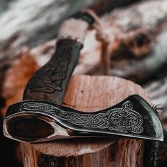 a knife sitting on top of a piece of wood