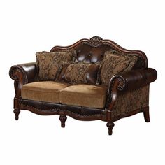 a brown couch with pillows on it and a wooden frame around the armrests