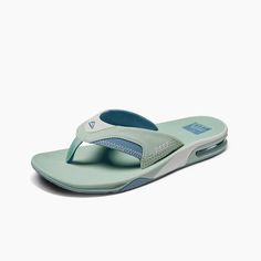 a women's flip flop sandal in mint green and white with blue accents