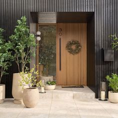 some potted plants are sitting in front of a door