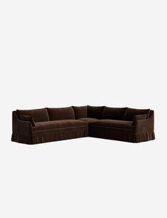 a brown sectional couch sitting on top of a white floor